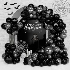 a black and white photo with balloons in the shape of a halloween wreath, bats and spider web