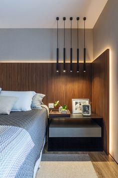 a modern bedroom with wood paneling and white bedding