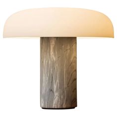 a table lamp with a white shade on it's base and a light bulb in the shape of a mushroom