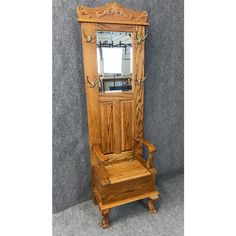 an old fashioned wooden mirror sitting on top of a shelf