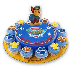 a paw patrol cake with cupcakes on it