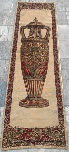 a large rug with a vase on it