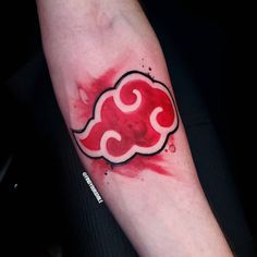 a red cloud tattoo on the arm