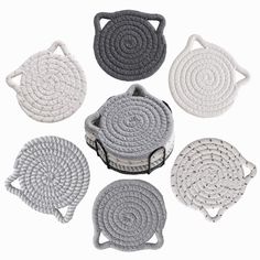 four crocheted coasters in different colors and sizes