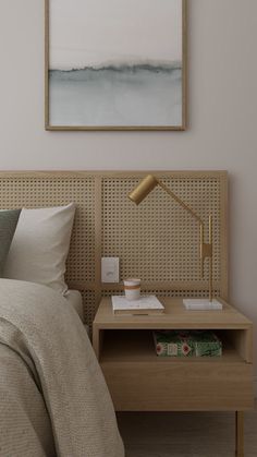 a bedroom with a bed, nightstand and painting on the wall above it's headboard