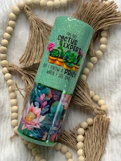 a tube of lip bale sitting on top of a white blanket next to wooden beads