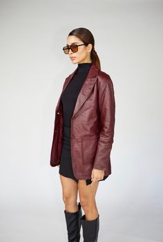 Express yourself in this stunning burgundy 90's inspired leather blazer. A staple blazer that can be worn dressed up or dressed down for all occasions year after year. Genuine sheepskin leather. Model is 5'8/119lbs wearing size small. Leather Blazer 90s, Vintage 90s Leather Jacket, Red Leather Blazer Outfit Aesthetic, Burgundy Leather Blazer Outfit, Vintage Leather Blazer, Burgundy Leather Blazer, Maroon Blazer Outfits For Women, Burgundy Leather Coat, Vintage Red Leather Jacket