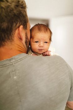 a man holding a baby in his arms