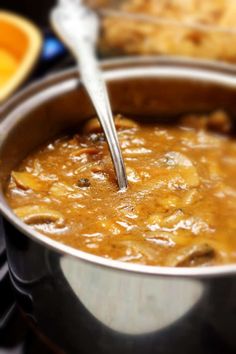 a spoon in a pot full of food