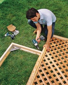 a man working on some wood in the grass