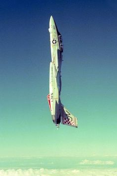 a fighter jet flying in the sky above clouds