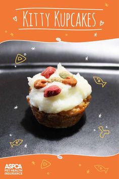 a cupcake with white frosting and fruit toppings on an orange background that says kitty kupekes