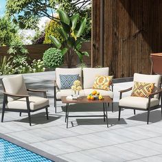 the patio furniture is set up by the pool