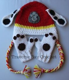 a crocheted dalmatian hat with ears and tail