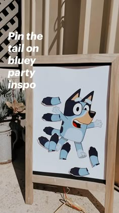 a wooden sign with an image of a cat on it and the words pin the tail on blue party inspo