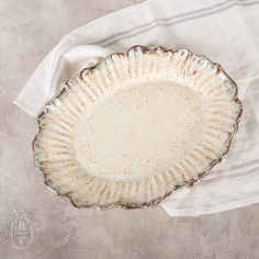 an empty pie plate sitting on top of a white towel