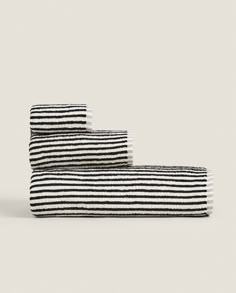 three black and white striped towels stacked on top of each other