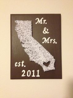 a wooden sign with string art on it that says mr and mrs est 2011 in white