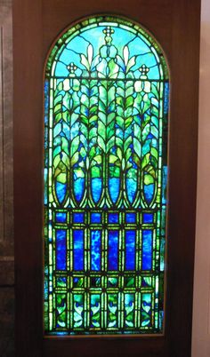 a stained glass window in a wooden door