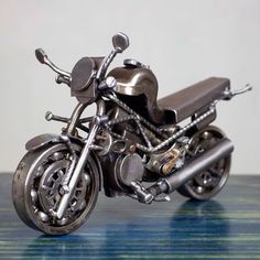 a metal model of a motorcycle on a table