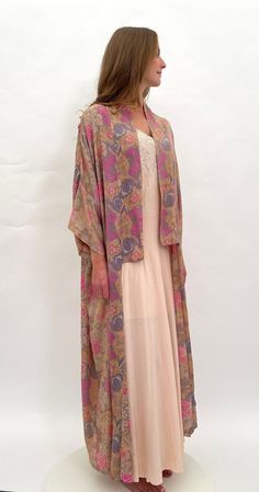 Take a step back in time to the romantic days of The Bloomsbury Group with this fine quality 1920s raw silk robe with a beautiful floral design. The colours are lovely, featuring pink, pale blue and white against a beige coloured ground. This robe was retailed by Selfridge in London (it is labelled to the inside of the neck). There are no ties or fastenings, this is meant to be worn loose and flowing for an unstructured  bohemian look. I love everything about this piece, it is just beautiful.  T Long Pink Silk Robe, Vintage Open Front Kimono For Summer, Vintage Open Front Summer Kimono, Vintage Silk Kimono For Summer, Summer Vintage Silk Kimono, Vintage Long Summer Robe, Vintage Pink Robe For Spring, Pink Silk Kimono For Spring, Vintage Multicolor Silk Kimono