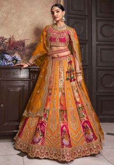 Orange banarasi silk lehenga choli 10291  Desc:  Style : Circular Lehenga Choli Color : Orange Fabric : Banarasi Silk Work : Embroidery   Sequence Wash Care : Dry clean Sleeve Style : Half Sleeve Long Sleeves : Done only in Custom Stitch Sleeves Lining : Done only in Custom Stitch Bust Size : 32 to 42 Inches Occasion : Wedding   Mehendi   Sangeet   Engagement   Reception   Ceremonial. With Express Free Shipping and Custom Stitching, Buy Lehenga - Indian Party wedding and bridal  Orange banarasi silk lehenga choli 10291 online in USA, UK and Canada from KollyBollyEthnics.com Luxury Banarasi Silk Choli With Resham Embroidery, Banarasi Silk Blouse Piece With Latkans For Traditional Ceremonies, Luxury Embroidered Banarasi Silk Lehenga, Luxury Banarasi Silk Lehenga With Intricate Embroidery, Luxury Banarasi Silk Lehenga With Gota Work, Luxury Semi-stitched Banarasi Silk Lehenga, Luxury Banarasi Silk Lehenga For Traditional Ceremonies, Luxury Banarasi Silk Floor-length Gown, Luxury Orange Lehenga With Zari Work