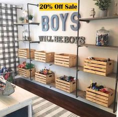 a room filled with lots of wooden boxes and shelves next to a wall mounted sign that says boys will be boys