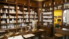 a room filled with lots of wooden shelves covered in jars and vases on top of them