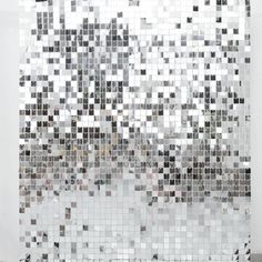 a white wall covered in lots of square tiles