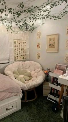 a bedroom with two beds and lots of pictures on the wall above them, all decorated in pastel colors