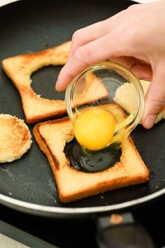 someone is frying eggs on toast in a skillet with butter and oil over them