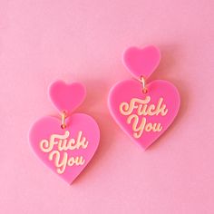 On a pink background is a hot pink pair of heart shaped earrings with ivory Fuck You on each heart. Trendy Pink Heart Earrings, Candy Heart Earrings, Uncut Gems, Pink Punk, Valentine Earrings, Clay Designs, Valentines Earrings, Heart Shaped Earrings, F U