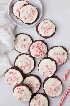 chocolate peppermint cookies with white frosting and sprinkles on top