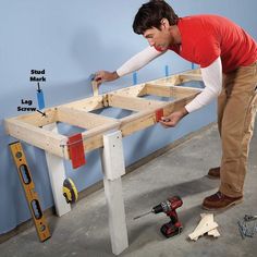 a man is working on a table made out of plywood and some screwdrivers