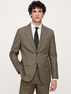 This sophisticated Italian wool suit jacket stands up to warm weather with a luxurious tropical wool fabric—a fabric beloved for its distinctive balance between an open weave and a tighter tension yarn, which gives it the ability to remain breathable while always looking pulled-together.  Tailored Slim Fit: More relaxed than our Slim Fit, this Italian cut style has a softer shoulder construction.  Fabric from Italy's Vitale Barberis Canonico.  Notch lapel with 2-button front.  Three exterior poc Brown Suit Wedding, Sound Of Music Costumes, Brown Suits For Men, Construction Fabric, Brown Suits, Suits And Jackets, Men’s Suits, Curly Hair Men, Open Weave