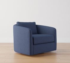 a blue chair sitting on top of a hard wood floor next to a white wall