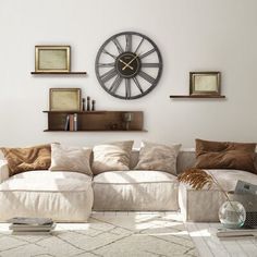 a living room filled with furniture and a large clock on the wall