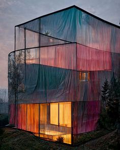 an unusual building with sheer curtains covering it