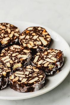 a white plate topped with brownies covered in chocolate