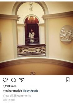 a woman taking a selfie in front of an ornate doorway with statues on either side