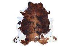 a brown and white cowhide rug is shown on a white background with the word,