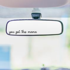 the rear view mirror on a car that says, you got this mama written on it