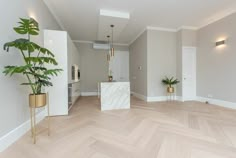 an empty living room with white walls and wood floors