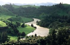 a river running through a lush green valley