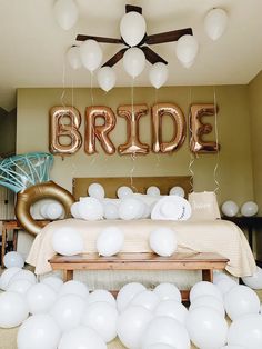 a table topped with balloons and large letters