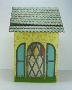 a small yellow house with two windows and a bird perched on the window sill