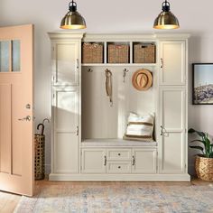 an entryway with white cabinets and baskets