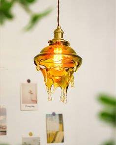 a yellow light hanging from a ceiling in a room