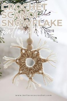 a crochet snowflake ornament hanging from a christmas tree branch