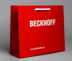 a red shopping bag with the words beckoff on it